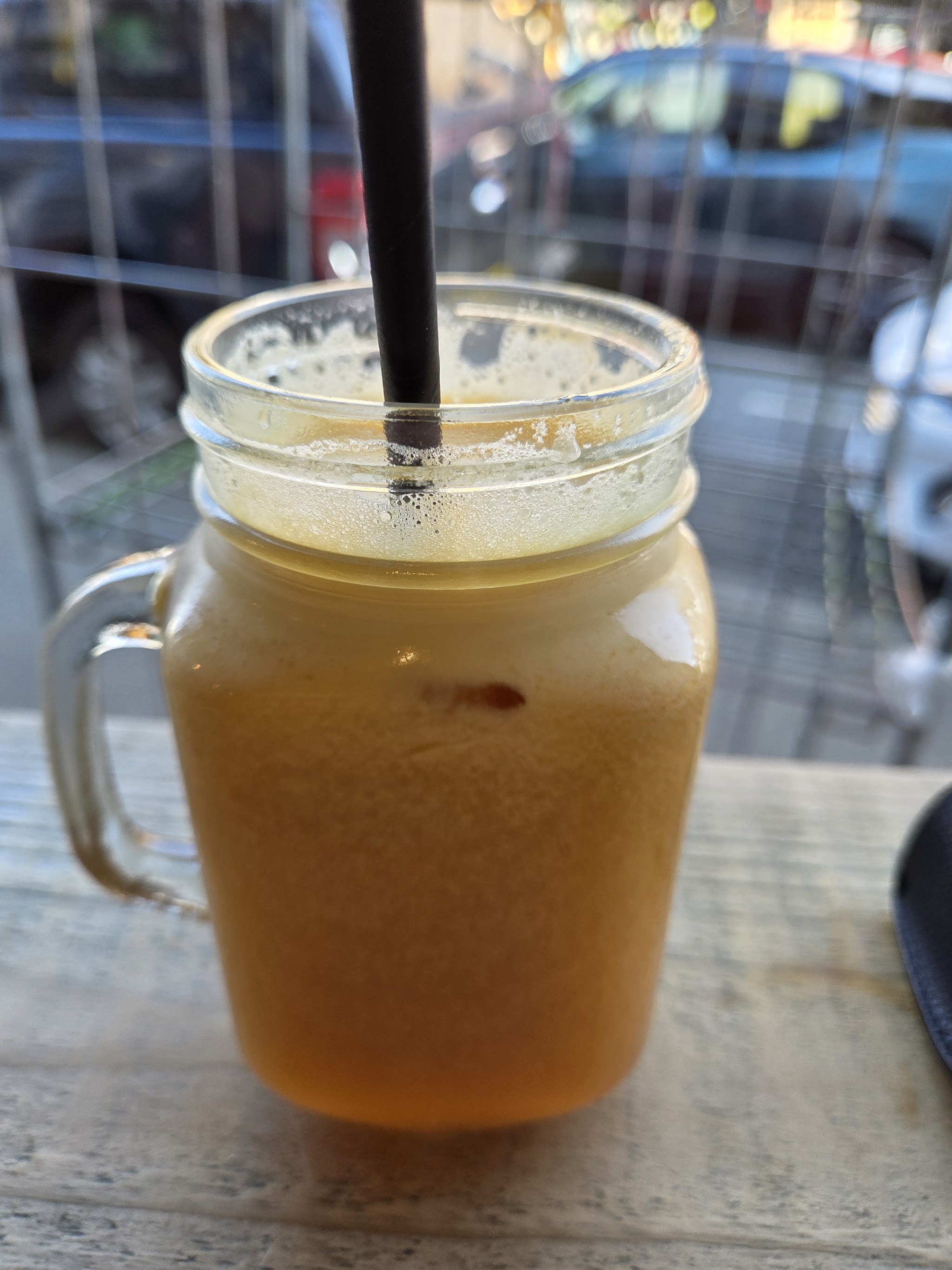 Fresh juice served in a glass jar by the window